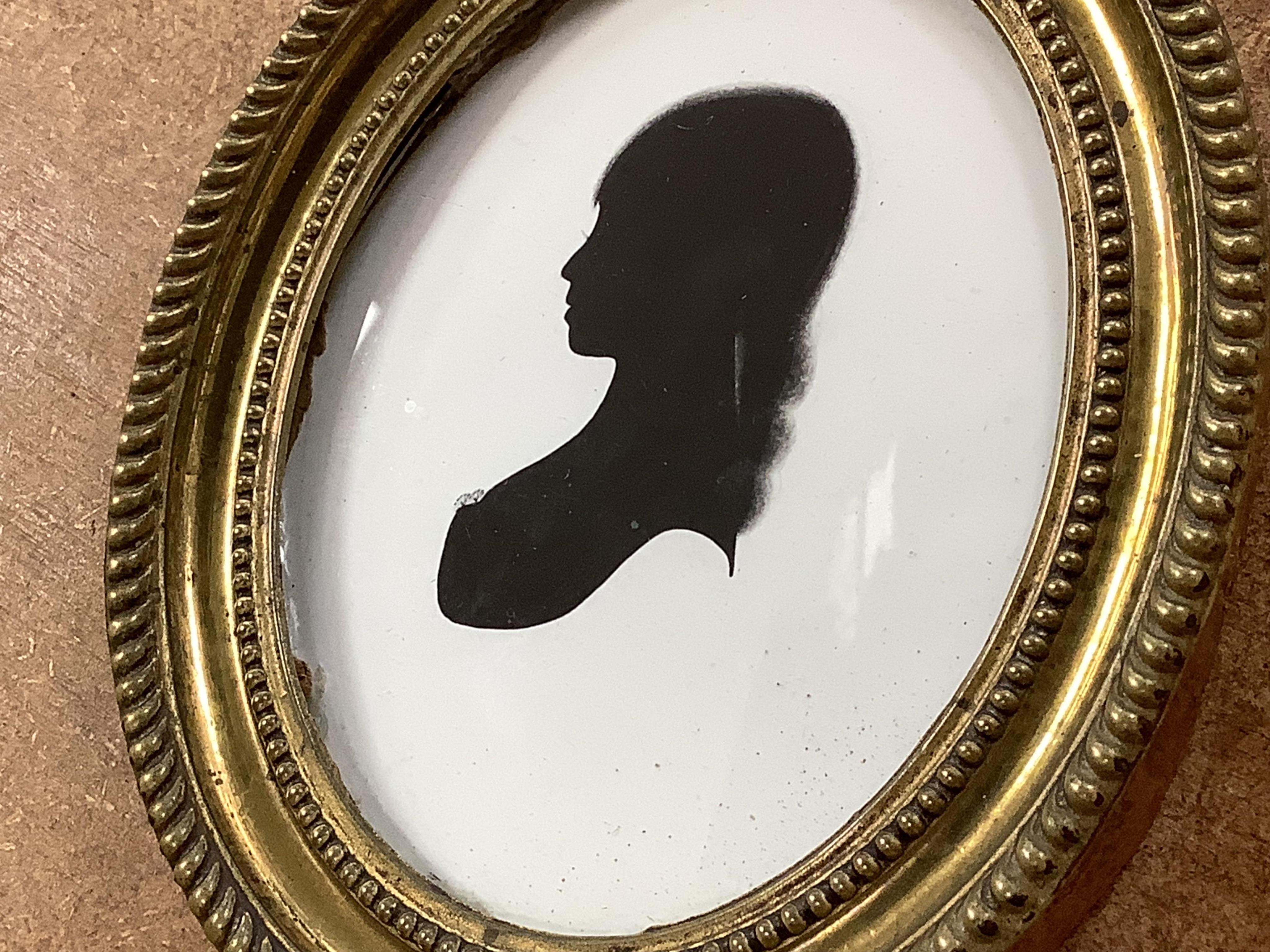 Mrs Mary Lightfoot (18th. C), oval painted silhouette portrait of a young lady, on plaster, printed trade label verso, embossed brass frame, overall 12cm high